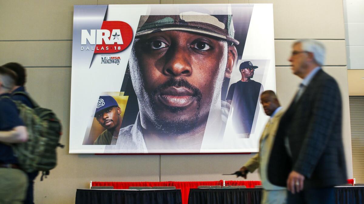 A poster with the face of Colion Noir, NRATV host, inside the 2018 NRA Annual Meetings & Exhibits at the Kay Bailey Hutchison Convention Center.