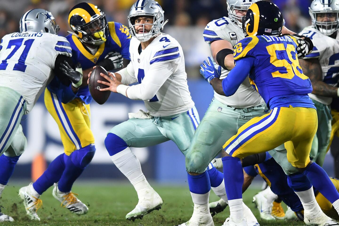 Cowboys quarterback Dak Prescott tries to escape the Rams rush.
