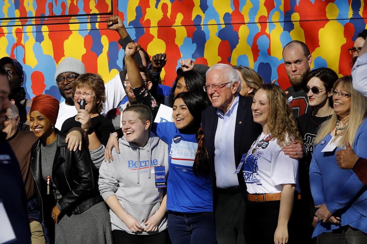 Sen. Bernie Sanders of Vermont and Rep. Ilhan Omar (D-Minn.), far left, at a campaign event Saturday at the Black Box Theater in Indianola, Iowa. (Pablo Martinez Monsivais / Associated Press)