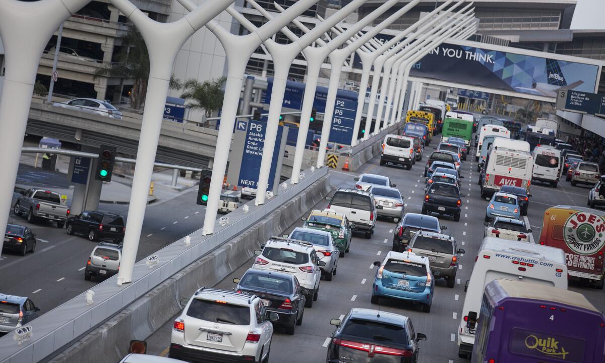 Traffic is jammed on the upper level for departing travelers at LAX on a Friday morning in May.