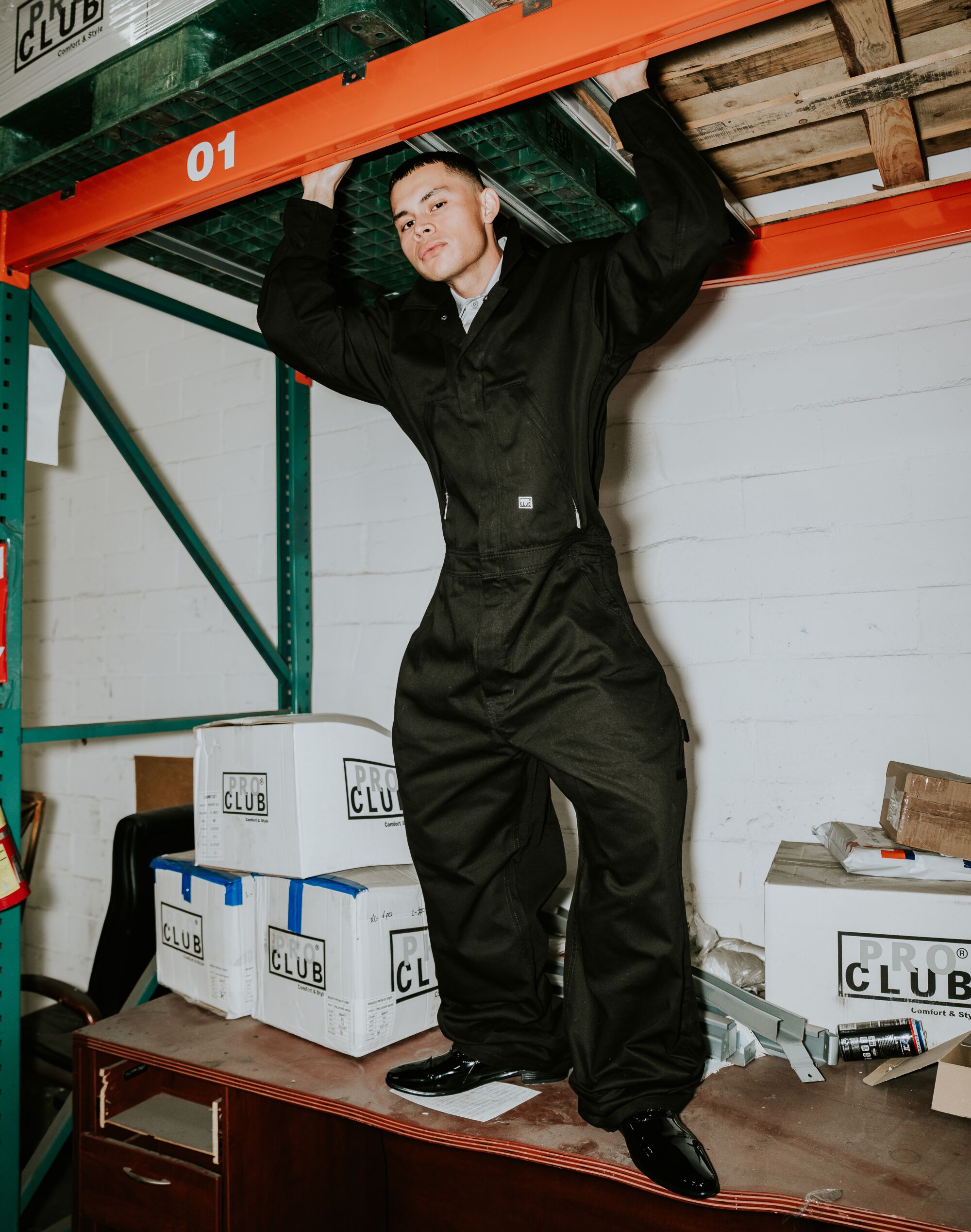 A model wears a Pro Club outfit in the brand's warehouse.