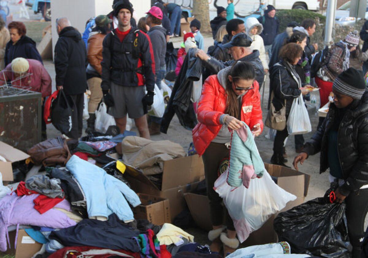Residents of the Sea Gate community in Coney Island, New York, sift through donated clothing.