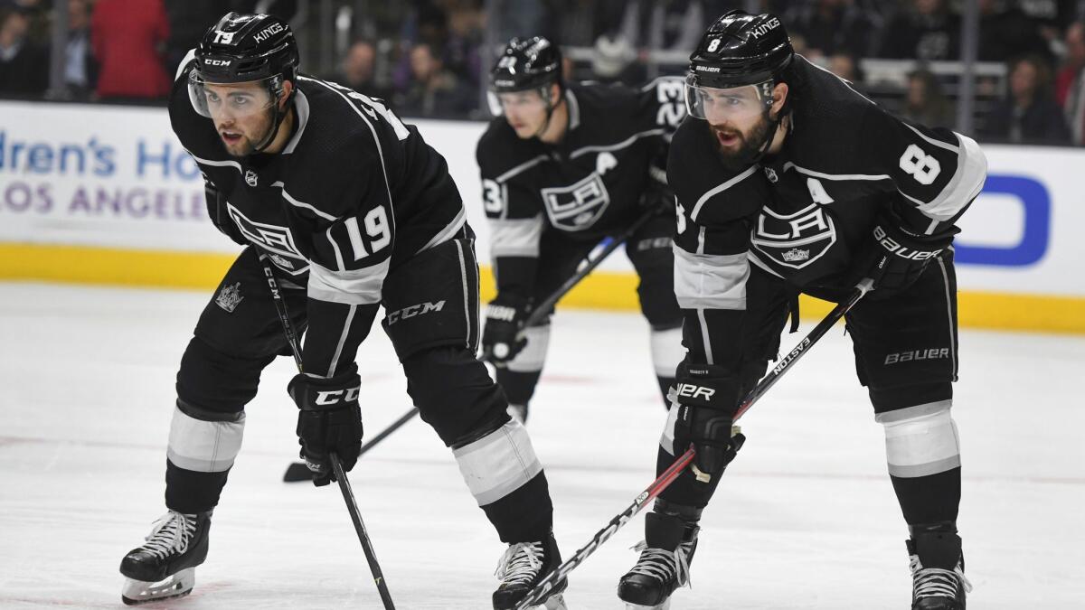 Kings center Alex Iafallo (19), right wing Dustin Brown (23), and defenseman Drew Doughty (8) line up for a faceoff during a game against the New York Rangers on Sunday.