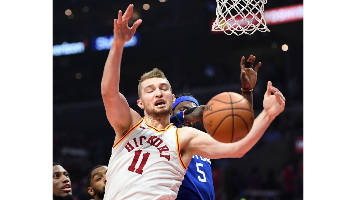 Pacers Domantas Sabonis and Clippers Montrezl Harrell battles for a rebound.