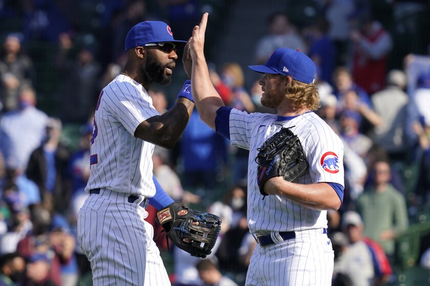 Chicago Cubs right fielder Jason Heyward, left, celebrates with relief pitcher Craig Kimbrel after they defeated the Pittsburgh Pirates in a baseball game in Chicago, Saturday, April 3, 2021. (AP Photo/Nam Y. Huh)