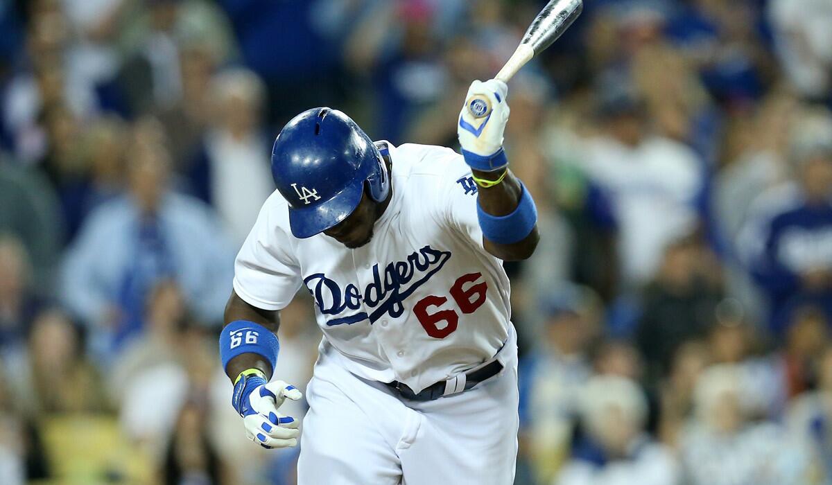 Dodgers right fielder Yasiel Puig slams his bat after popping out to end the fifth inning against the Pirates on Friday night.
