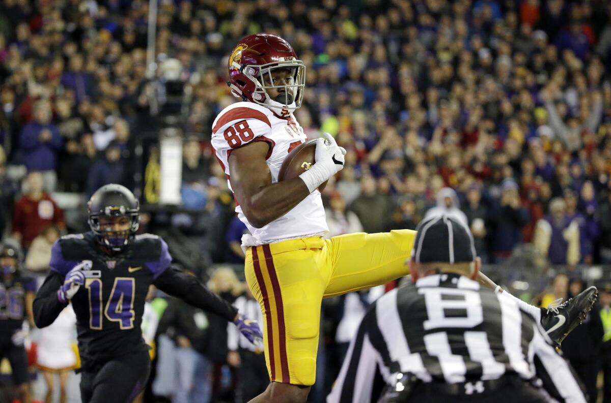 USC tight end Daniel Imatorbhebhe (88) comes down in the end zone as he catches a touchdown pass in front of Washington's Jojo McIntosh in the second half.