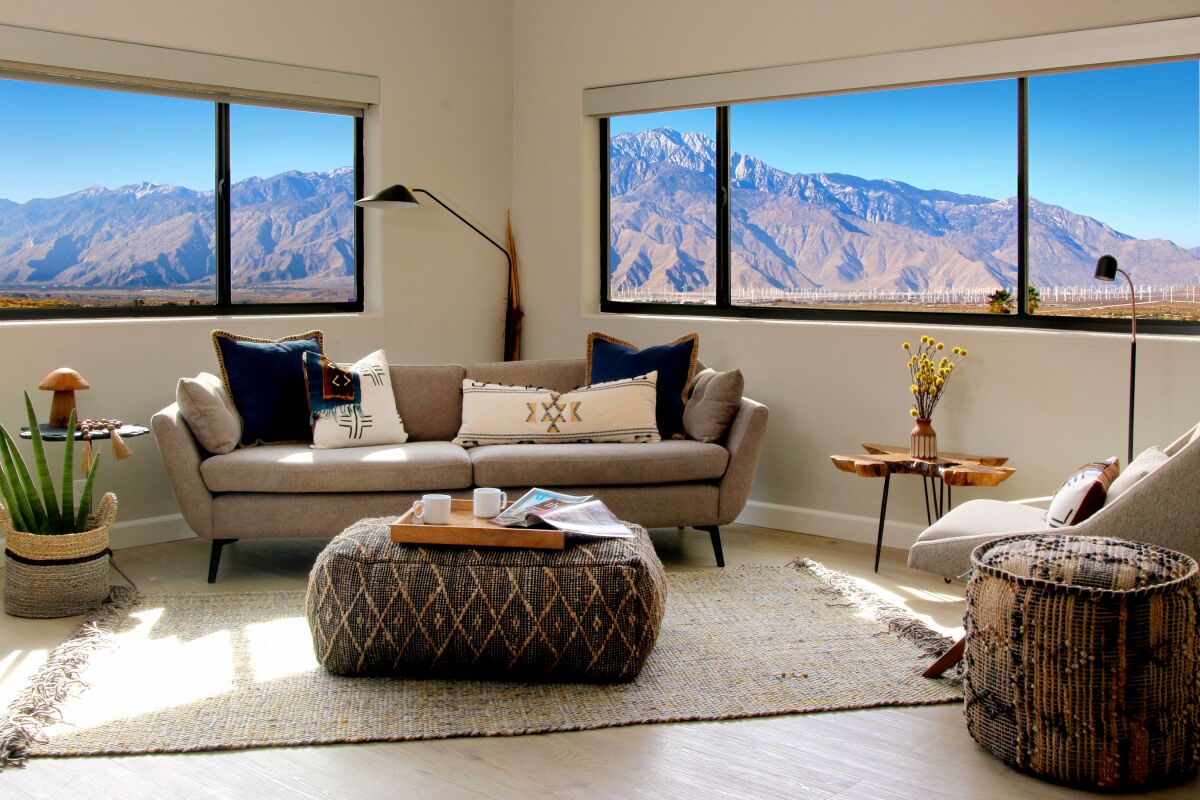 A sitting area with contemporary furniture and a view of the mountains
