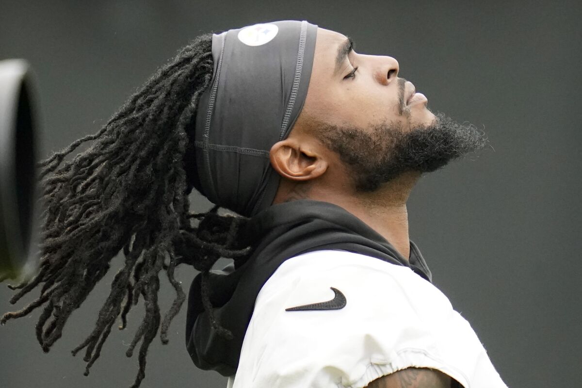 Pittsburgh Steelers wife receiver Diontae Johnson flips his hair back as he warms up during an NFL football practice, Tuesday, June 7, 2022, in Pittsburgh. (AP Photo/Keith Srakocic)