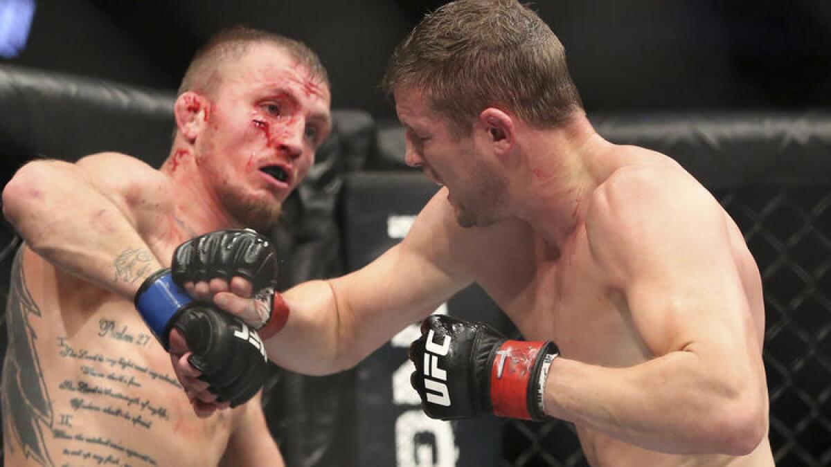 Jason Knight, left, and Chas Skelly trade punches during their UFC 211 bout on Saturday night in Dallas. To see more images from the UFC 211 card, click on the photo above.