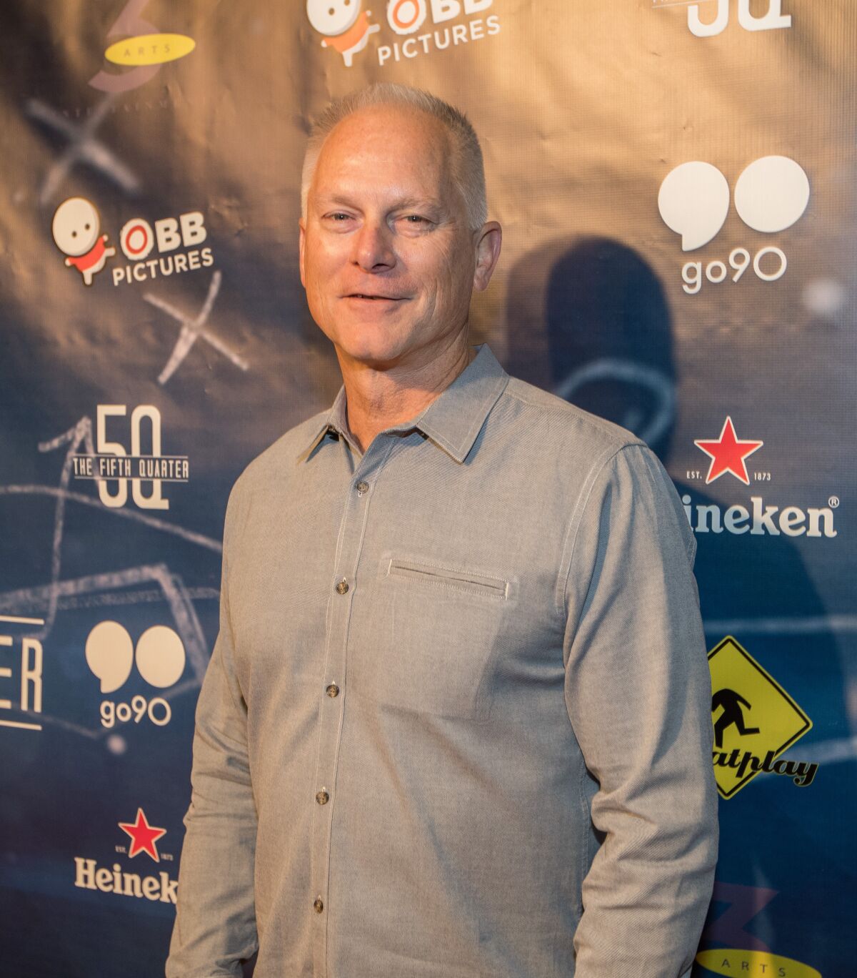 Kenny Mayne smiles while attending an event.