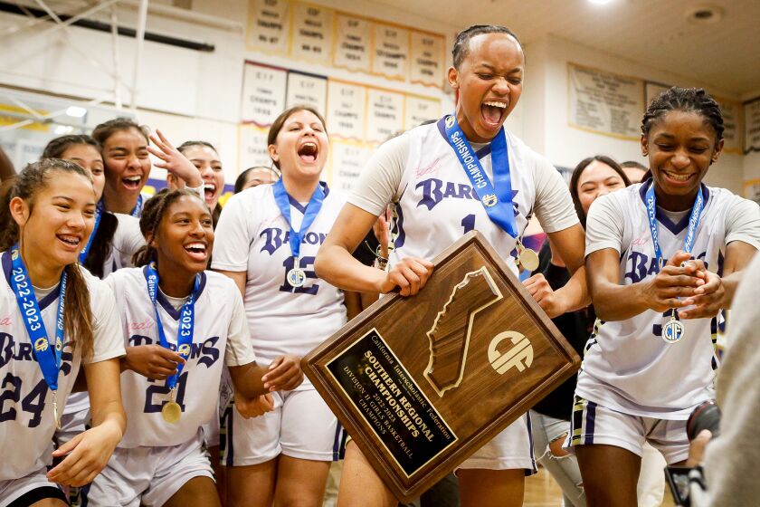Chula Vista, CA - March 07: Bonita Vista's Mahliya Wilson (1), and teammates celebrate with the trophy after the Barons beat Leuzinger 80-67 during the CIF State Girls Basketball Regional Championship - Division II at the school on Tuesday, March 7, 2023 in Chula Vista, CA. (Meg McLaughlin / The San Diego Union-Tribune)
