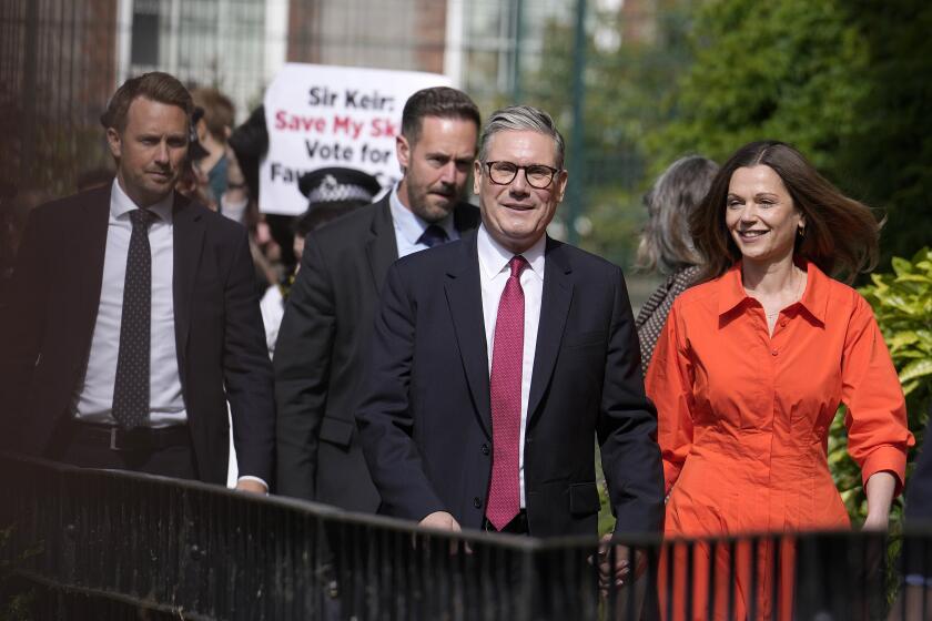 Labour Party leader Keir Starmer and wife Victoria arrive at a polling station to cast their vote in London, Thursday, July 4, 2024. Voters in the U.K. are casting their ballots in a national election to choose the 650 lawmakers who will sit in Parliament for the next five years. Outgoing Prime Minister Rishi Sunak surprised his own party on May 22 when he called the election. (AP Photo/Vadim Ghirda)