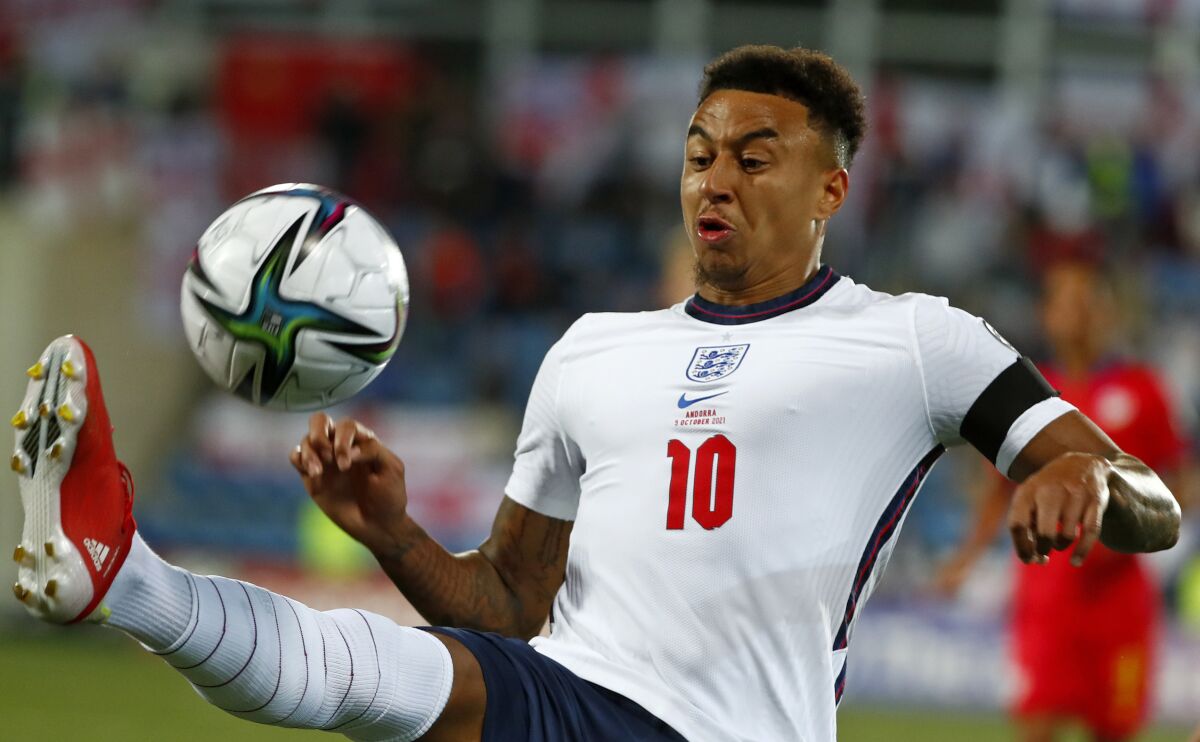 England's Jesse Lingard goes for the ball during the World Cup 2022 group I qualifying soccer match between Andorra and England at the National Stadium in Andorra la Vella, Saturday, Oct. 9, 2021. Manchester United manager Ralf Rangnick says Mason Greenwood’s suspension played a role in the club’s decision to keep Jesse Lingard until the end of the season. Greenwood was arrested on Sunday and questioned on suspicion of the rape and assault of a woman. He was released on bail on Wednesday and United has said the 20-year-old forward “will not train with, or play for, the club until further notice.” (AP Photo/Joan Monfort)