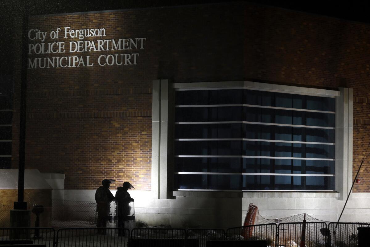 Members of the Missouri National Guard stand outside the Ferguson, Mo., Police Department and Municipal Court in November.
