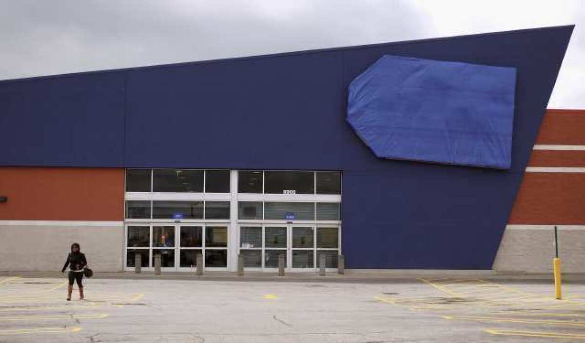A person walks away from a shuttered Best Buy store in Chicago. The electronics retailer said income slid 26% in the first quarter.