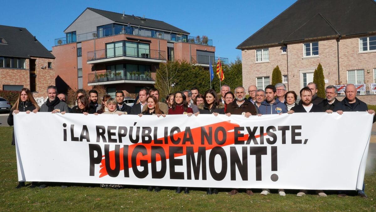 Spain's Ciudadanos party leader Ines Arrimadas, center, poses with supporters and an a banner reading "The republic does not exist, Puigdemont!" in front of former Catalan leader Carles Puigdemont house in Waterloo, Belgium, in late February 2019.