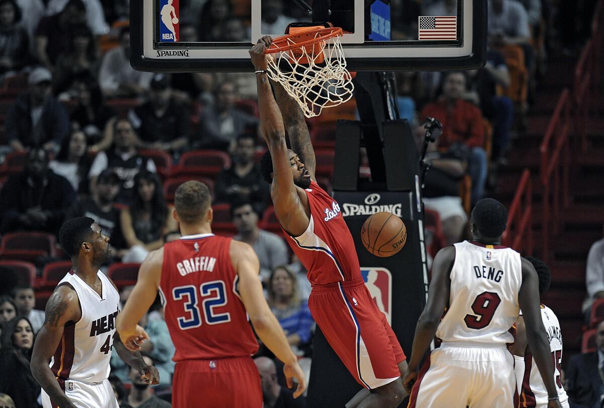 DeAndre Jordan dunks in front of the Heat defense Thursday at American Airlines Arena in Miami.