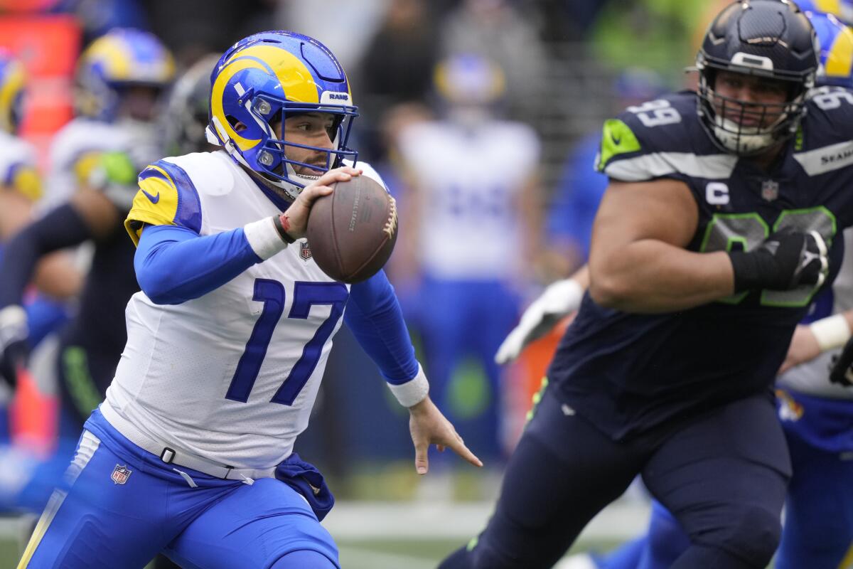 Rams quarterback Baker Mayfield scrambles against the Seattle Seahawks on Sunday.