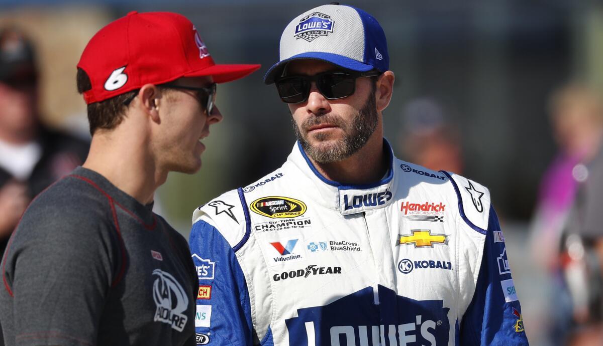 Jimmie Johnson, right, chats with fellow NASCAR driver Trevor Bayne before a Sprint Cup qualifying session.