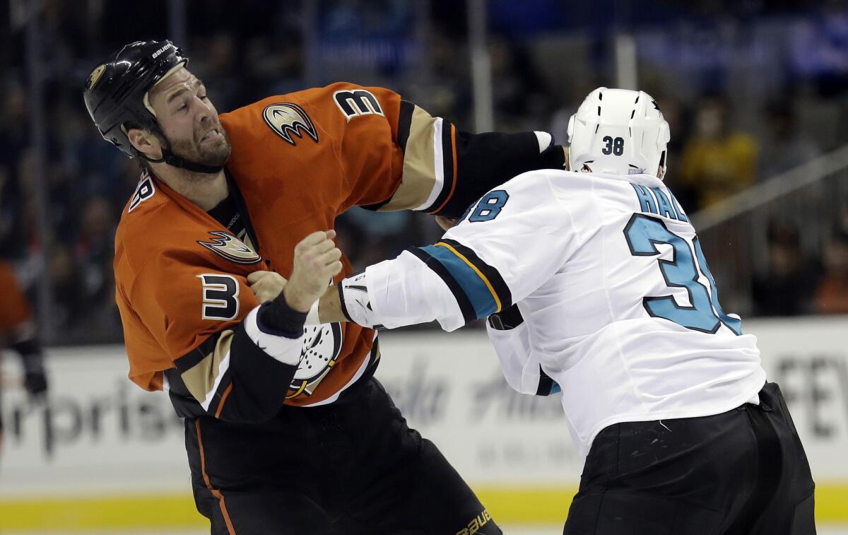 Ducks defenseman Clayton Stoner (3) fights with San Jose Sharks' Micheal Haley during the first period on Oct. 25.