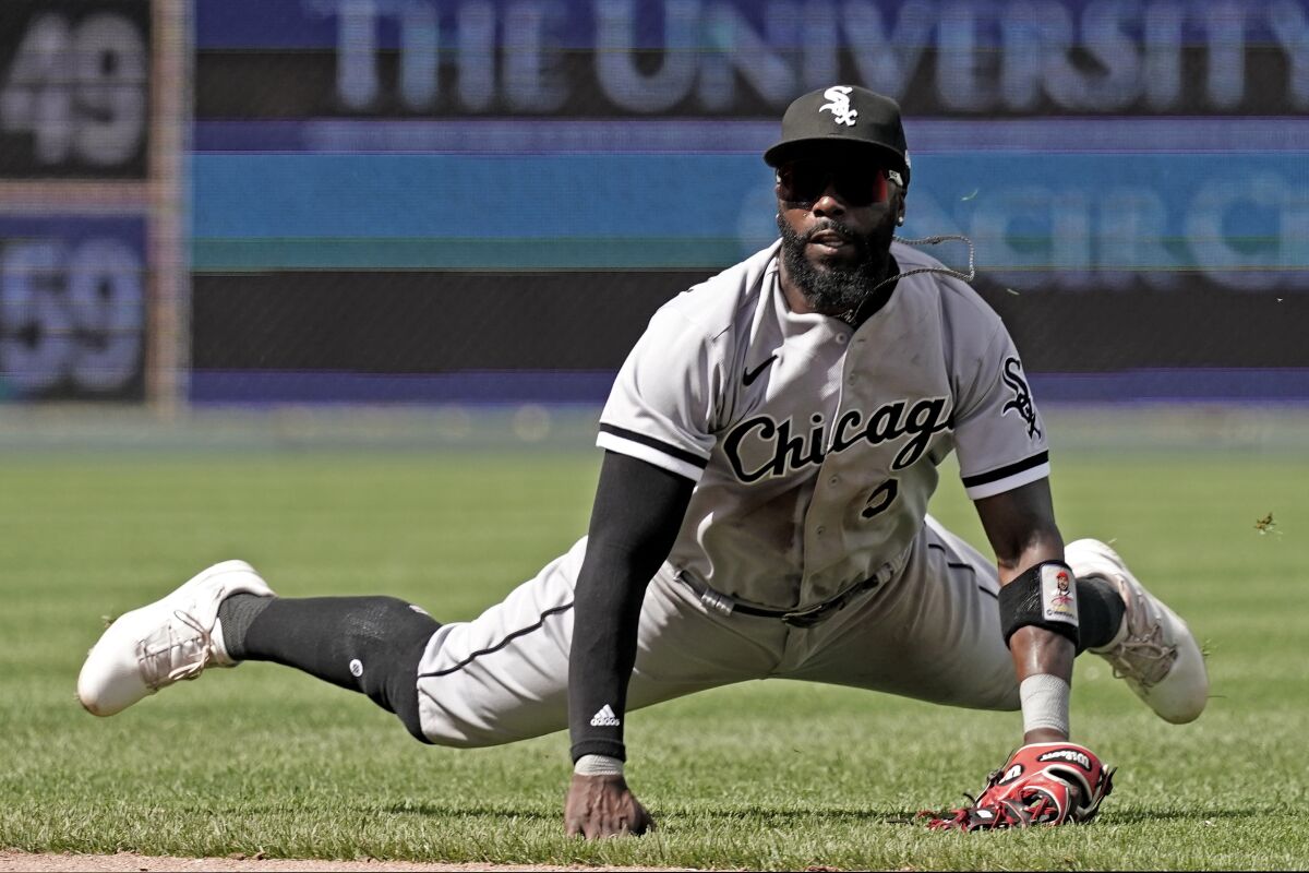 Chicago White Sox second baseman Josh Harrison watches his throw to first for the out on Kansas City Royals' Whit Merrifield during the seventh inning of a baseball game Thursday, May 19, 2022, in Kansas City, Mo. (AP Photo/Charlie Riedel)