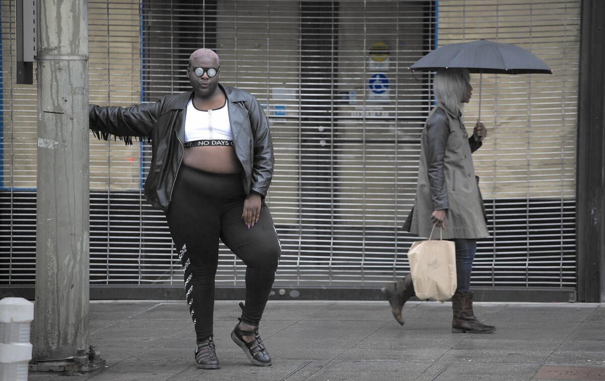 Jamal Lewis, a gender nonconforming documentarian, poses for a portrait on Third Street and Broadway in Los Angeles. Lewis is working on "No Fats, No Femmes," about desire and body image in the queer community.