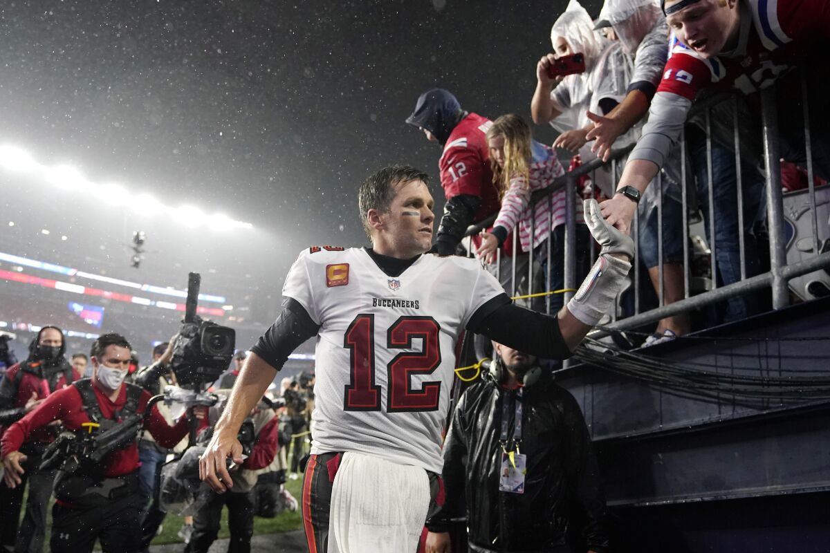 Tampa Bay Buccaneers quarterback Tom Brady (12) is congratulated by fans after defeating the New England Patriots 19-17 in an NFL football game, Sunday, Oct. 3, 2021, in Foxborough, Mass. (AP Photo/Steven Senne)
