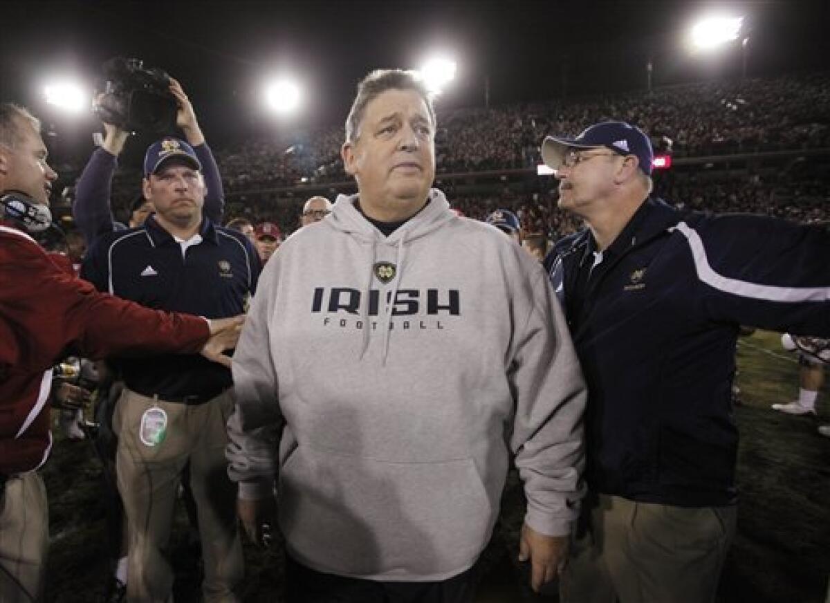 Notre Dame head coach Charlie Weis walks off the field after Stanford defeated Notre Dame 45-38 in their NCAA college football game in Stanford, Calif., Saturday, Nov. 28, 2009. (AP Photo/Paul Sakuma)
