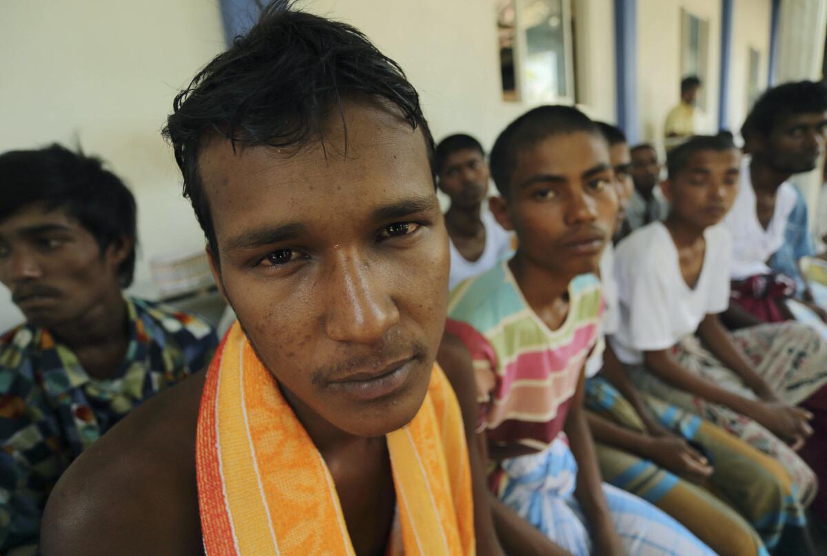 Rescued Rohingya Muslims sit at a Sri Lankan immigration detention center in Colombo on Wednesday.