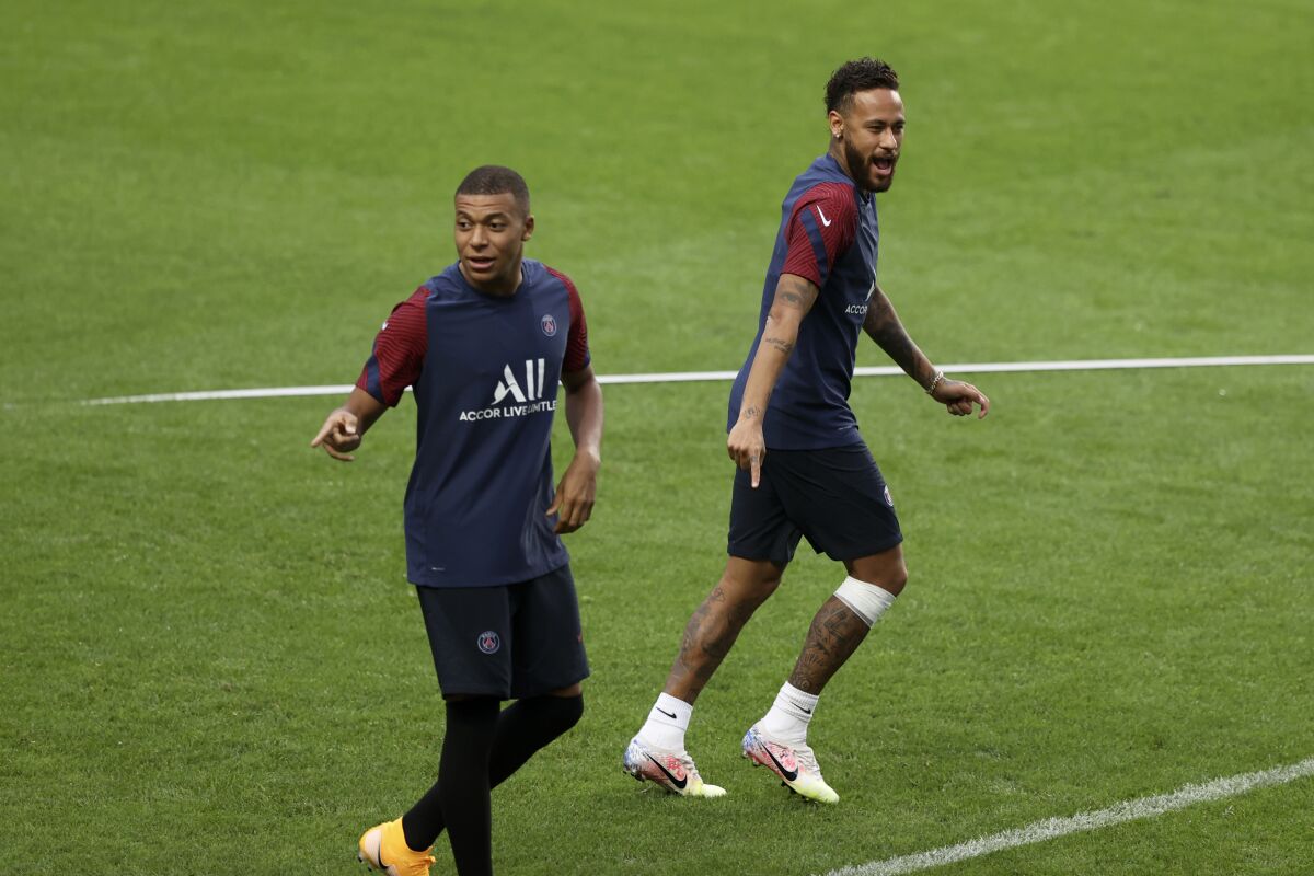 PSG's Kylian Mbappe and Neymar, right, gesture during a training session at the Luz stadium in Lisbon, Tuesday Aug. 11, 2020. PSG will play Atalanta in a Champions League quarterfinals soccer match on Wednesday. (Rafael Marchante/Pool via AP)