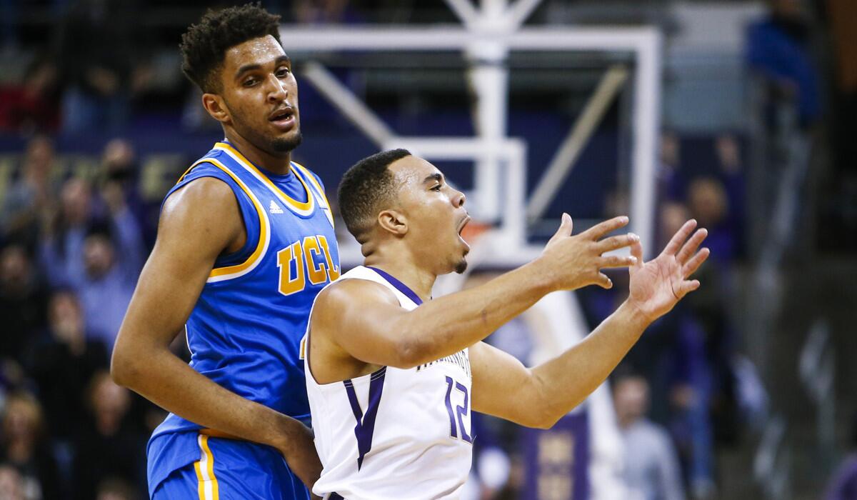 Washington guard Andrew Andrews (12) reacts after making a shot as UCLA forward Jonah Bolden stands behind him during the second overtime on Jan. 1, 2016.