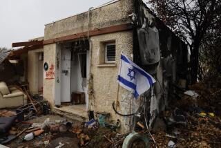 An Israeli flag hangs outside a home in Sha’ar HaNegev two months after the kibbutz was attacked by Hamas on Oct. 7.