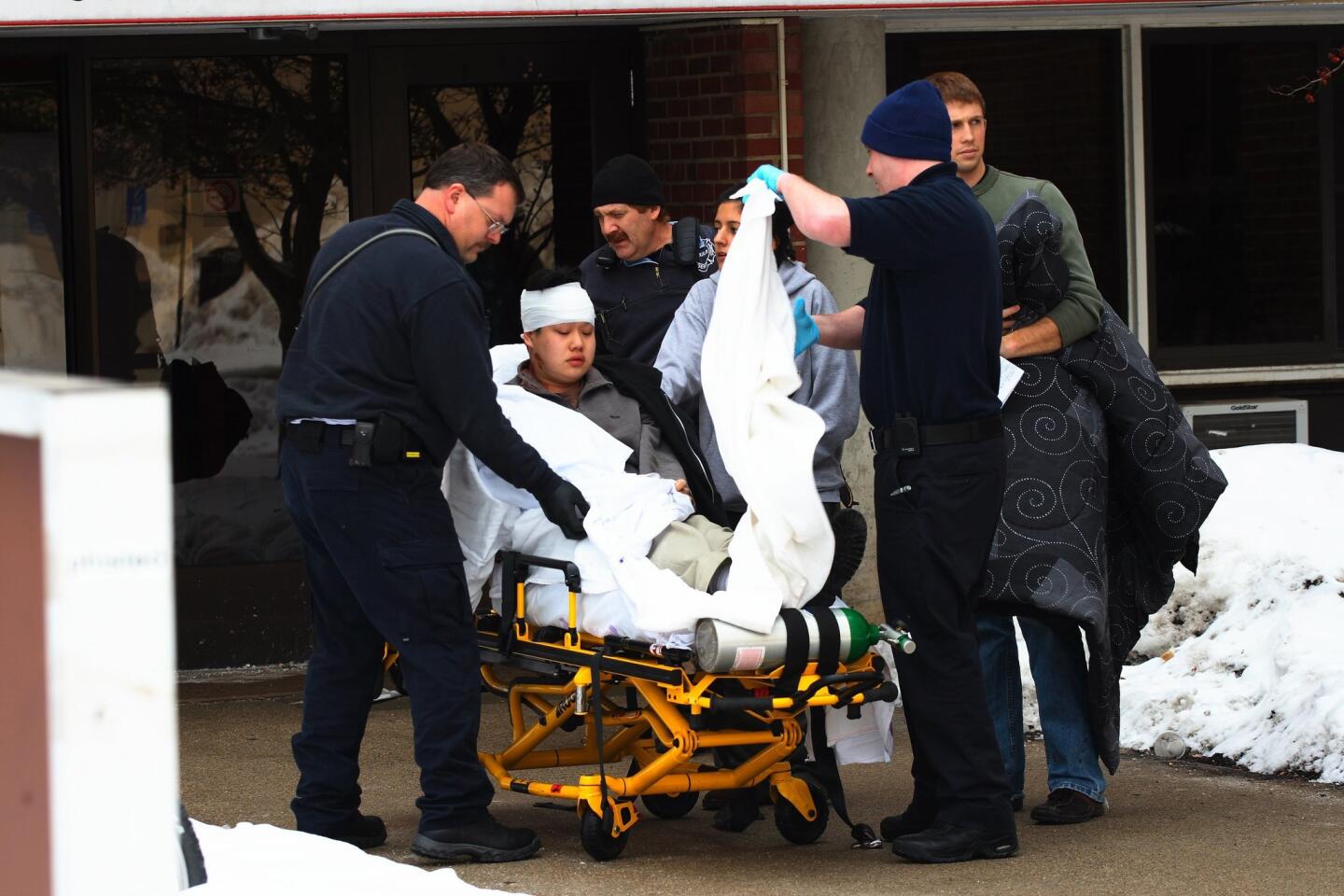 Emergency personnel prepare to transport student Harold Ng out of Neptune Hall, a residence hall at Northern Illinois University, Feb. 14, 2008, in DeKalb. Ng was later released from the hospital.