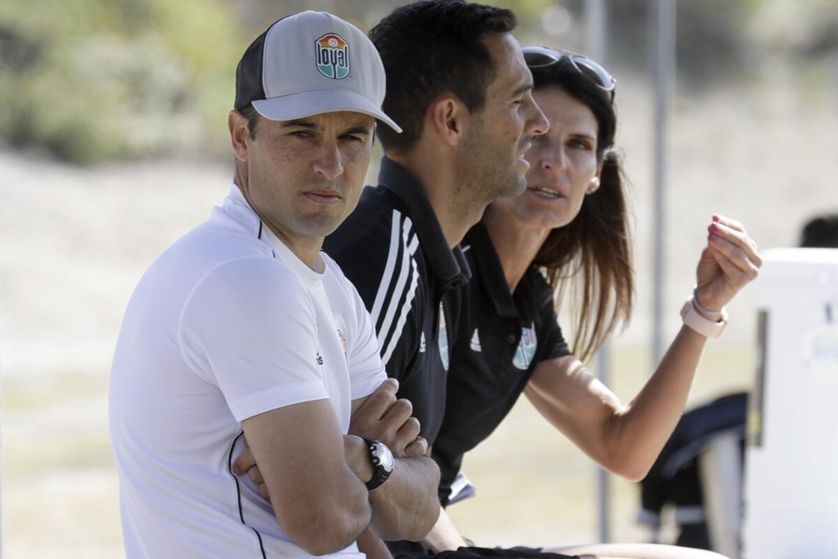 Coach Landon Donovan, left, sits next to assistants Nate Miller and Carrie Taylor at a San Diego Loyal scrimmage.