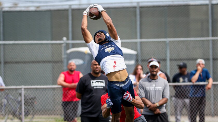 St. John Bosco wide receiver Kris Hutson makes a leaping touchdown catch over Mater Dei cornerback Domani Jackson during the championship game at the Battle of the Beach seven-on-seven tournament in Huntington Beach on June 29.