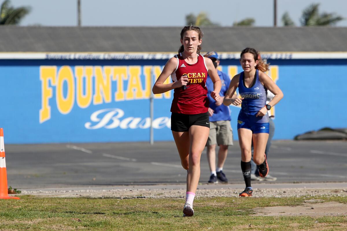 Ocean View's Elizabeth King competes against Fountain Valley's Samantha Martinez during a cross-country dual meet Saturday.