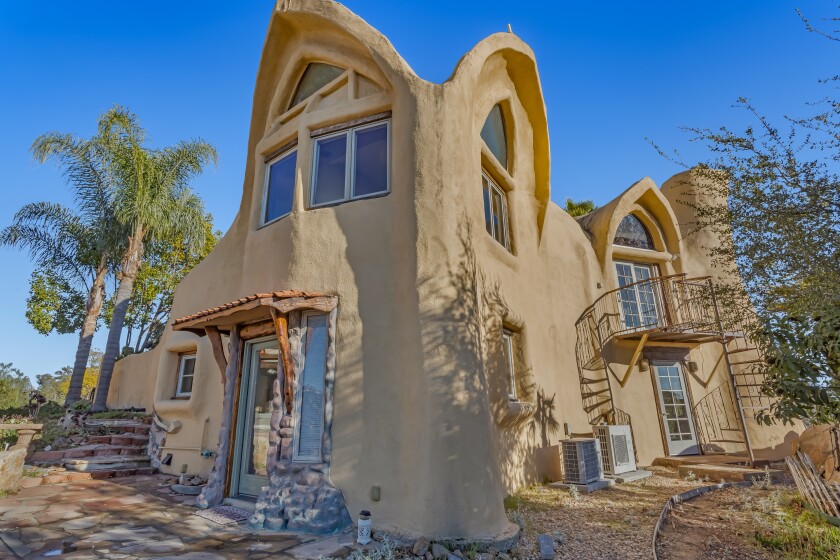 A cave-like home built to blend in with the craggy, rock-laden hills that surround it.