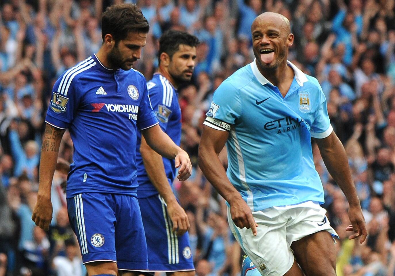 Manchester City's Vincent Kompany, right, celebrates after scoring against Chelsea during the English Premier League soccer match between Manchester City and Chelsea at Etihad stadium, Manchester, England, Sunday, Aug. 16, 2015. (AP Photo/Rui Vieira)