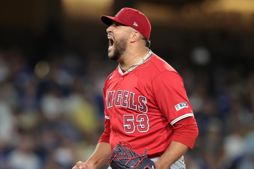 Angels closer Carlos Estevez celebrates after striking out Gavin Lux in the 10th inning.