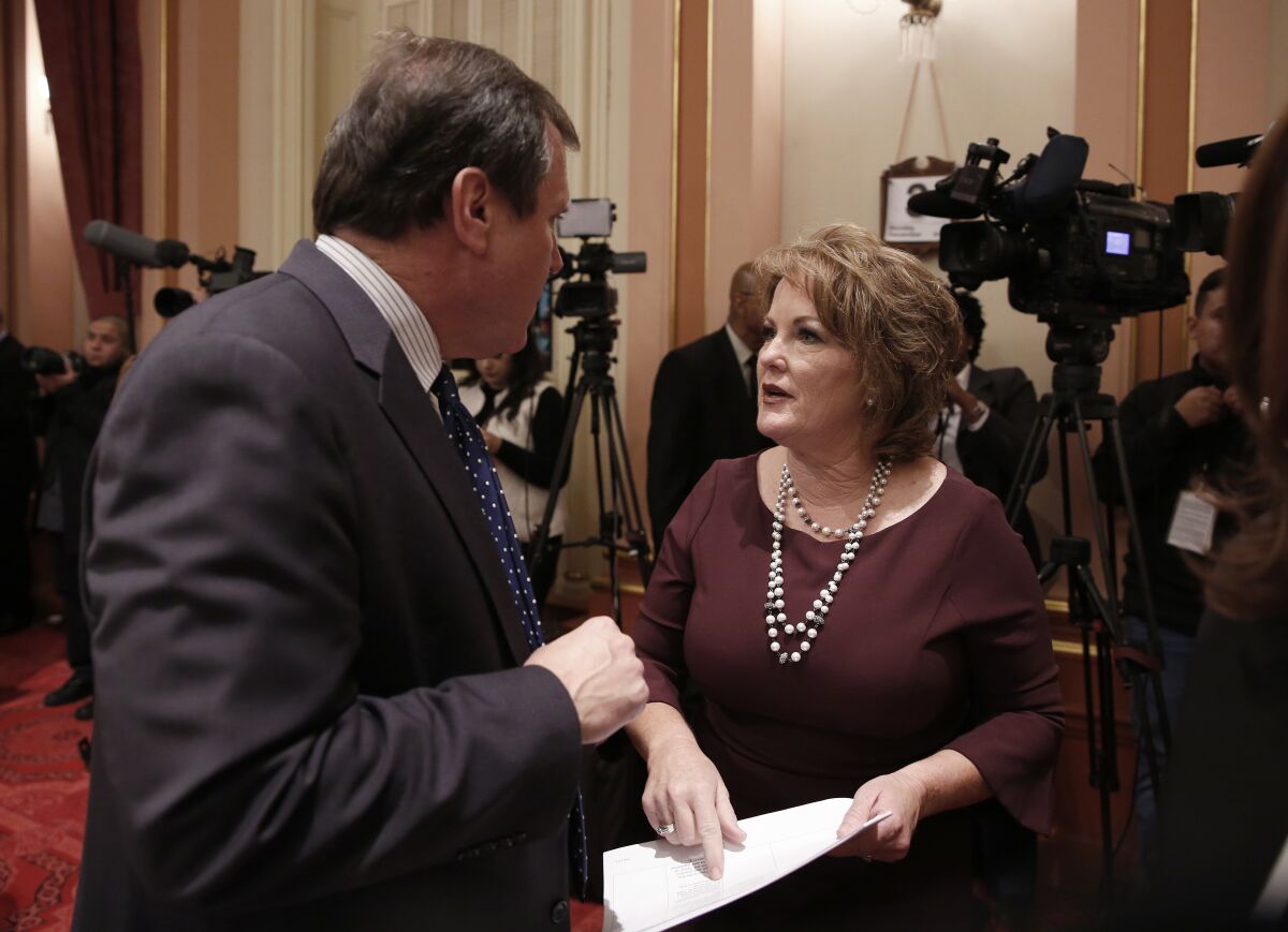 State Sen. Shannon Grove talks to Sen. Scott Wilk, R-Santa Clarita during state Senate session in 2018.