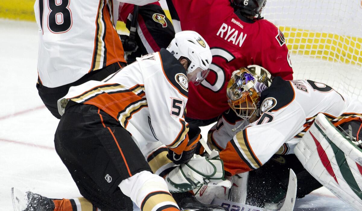 Senators right wing Bobby Ryan is sent crashing into Ducks goalie Ilya Bryzgalov by right wing Tim Jackman (18) and left wing Dany Heatley during their game Friday night in Ottawa.