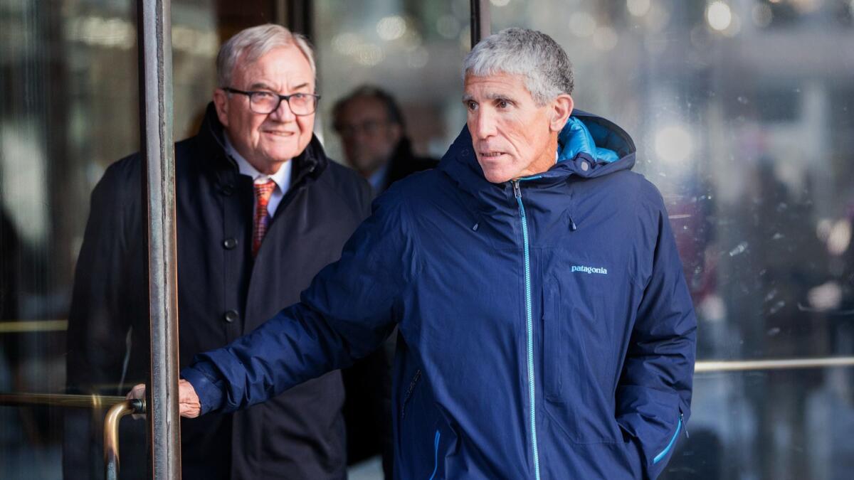 William “Rick” Singer, right, the admitted ringleader of an immense academic fraud, leaves federal court in Boston on Tuesday.