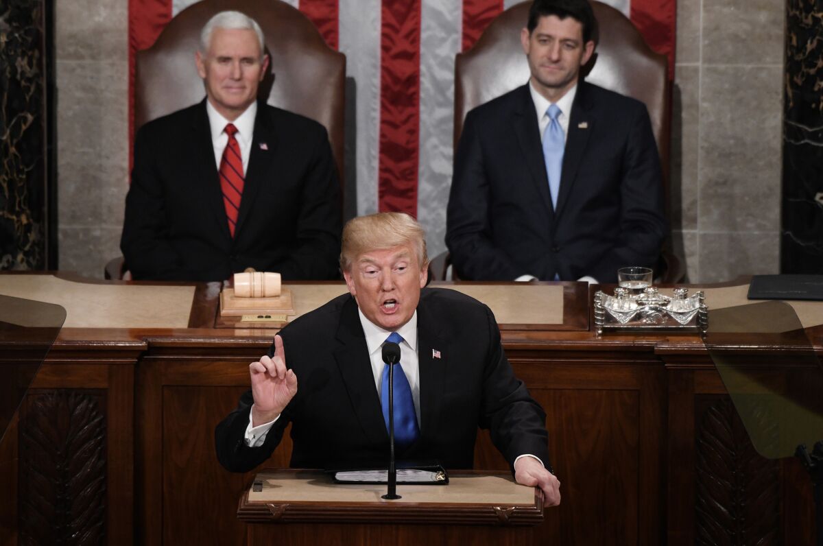 President Trump delivers his State of the Union address before a joint session of Congress on Capitol Hill in Washington on Tuesday. Behind him are Vice President Mike Pence, left, and Speaker of the House Paul Ryan.