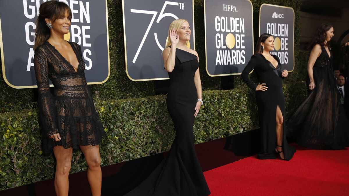 Halle Berry, left, Reese Witherspoon and Eva Longoria arriving at the Golden Globes in Beverly Hills in 2018, when Time's Up and #MeToo drove the red carpet conversations. Will this year be different?