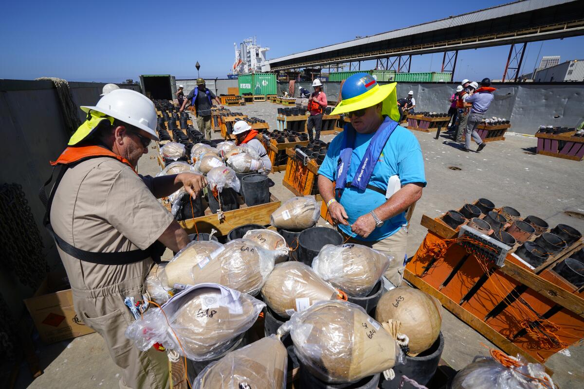 Sam Bruggema (r), pyro show producer, along with Jim Lewis (l) loaded the 6-inch mortar tubes with fireworks.