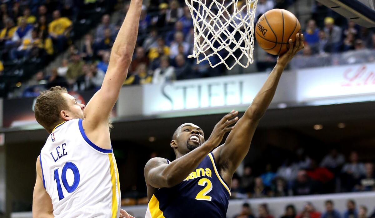 Pacers guard Rodney Stuckey has his layup challenged by Warriors forward David Lee during their game Sunday in Indianapolis.