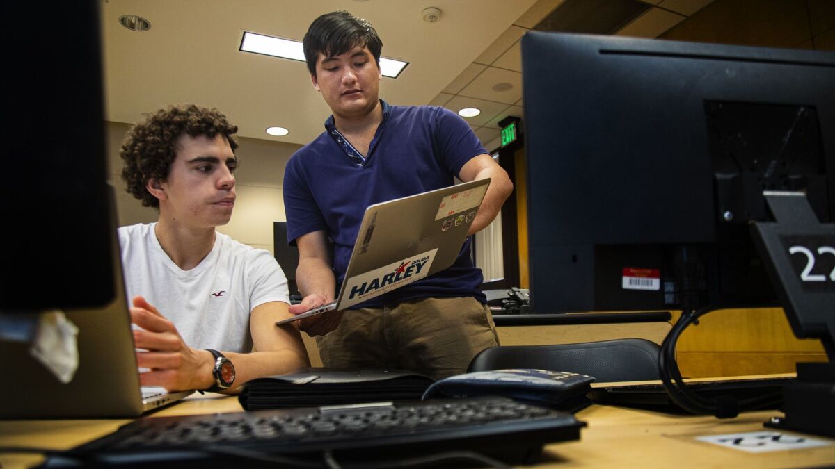 Bruno Youn, right, helps sophomore Juan Diego Herrera in a computer coding class at Claremont McKenna College.