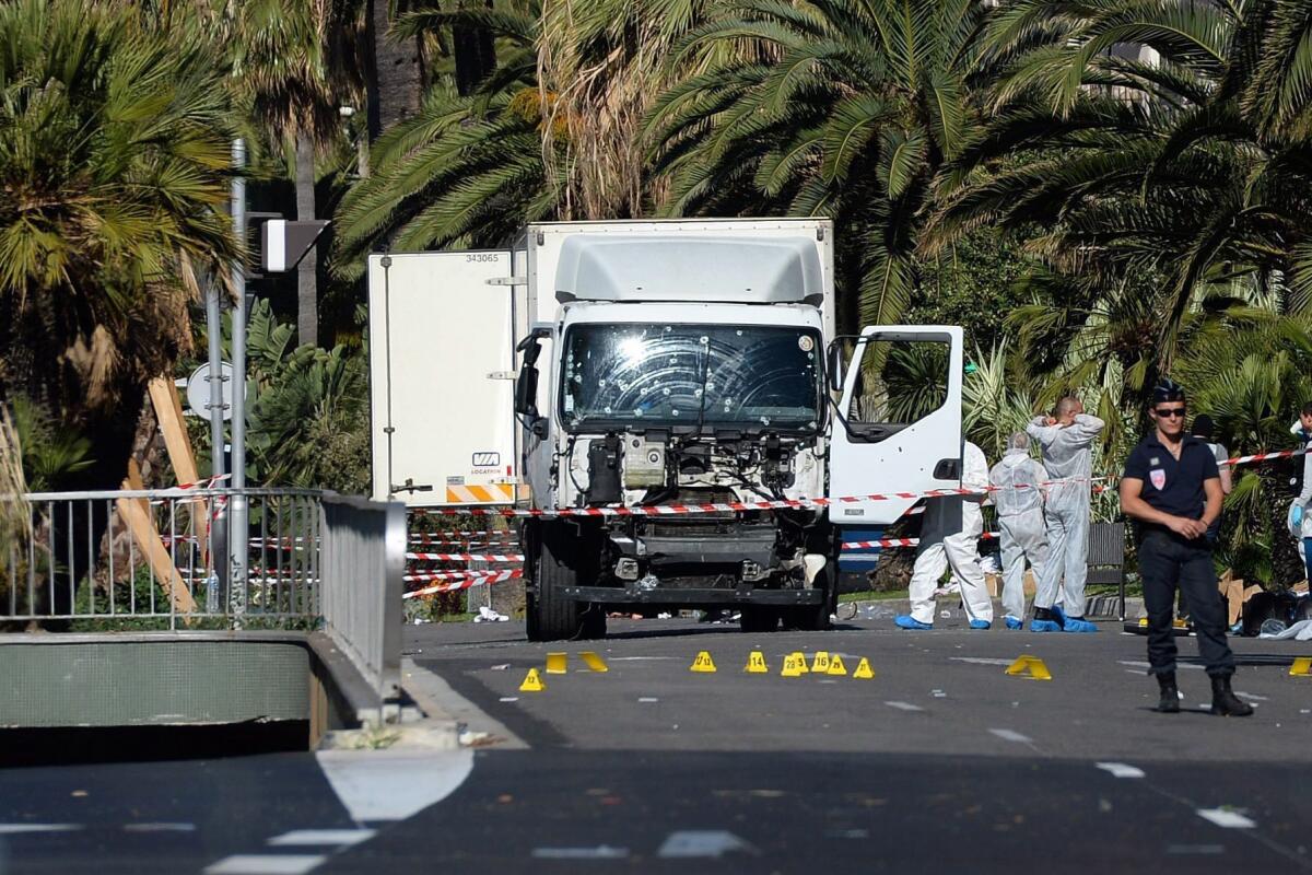 Police secure the area where a truck drove into a crowd during Bastille Day celebrations in Nice, France, killing scores of people.