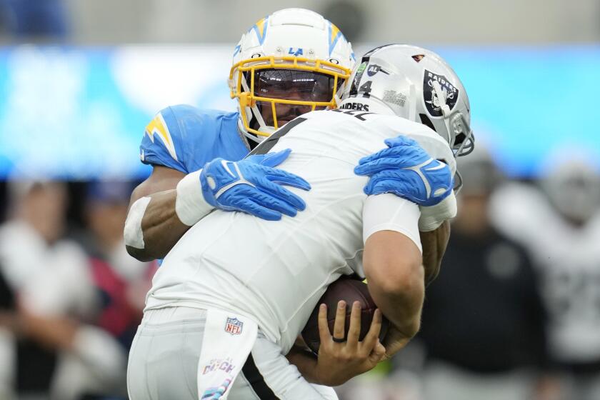 Los Angeles Chargers linebacker Khalil Mack, left, sacks Las Vegas Raiders quarterback Aidan O'Connell during the first half of an NFL football game Sunday, Oct. 1, 2023, in Inglewood, Calif. (AP Photo/Ashley Landis)